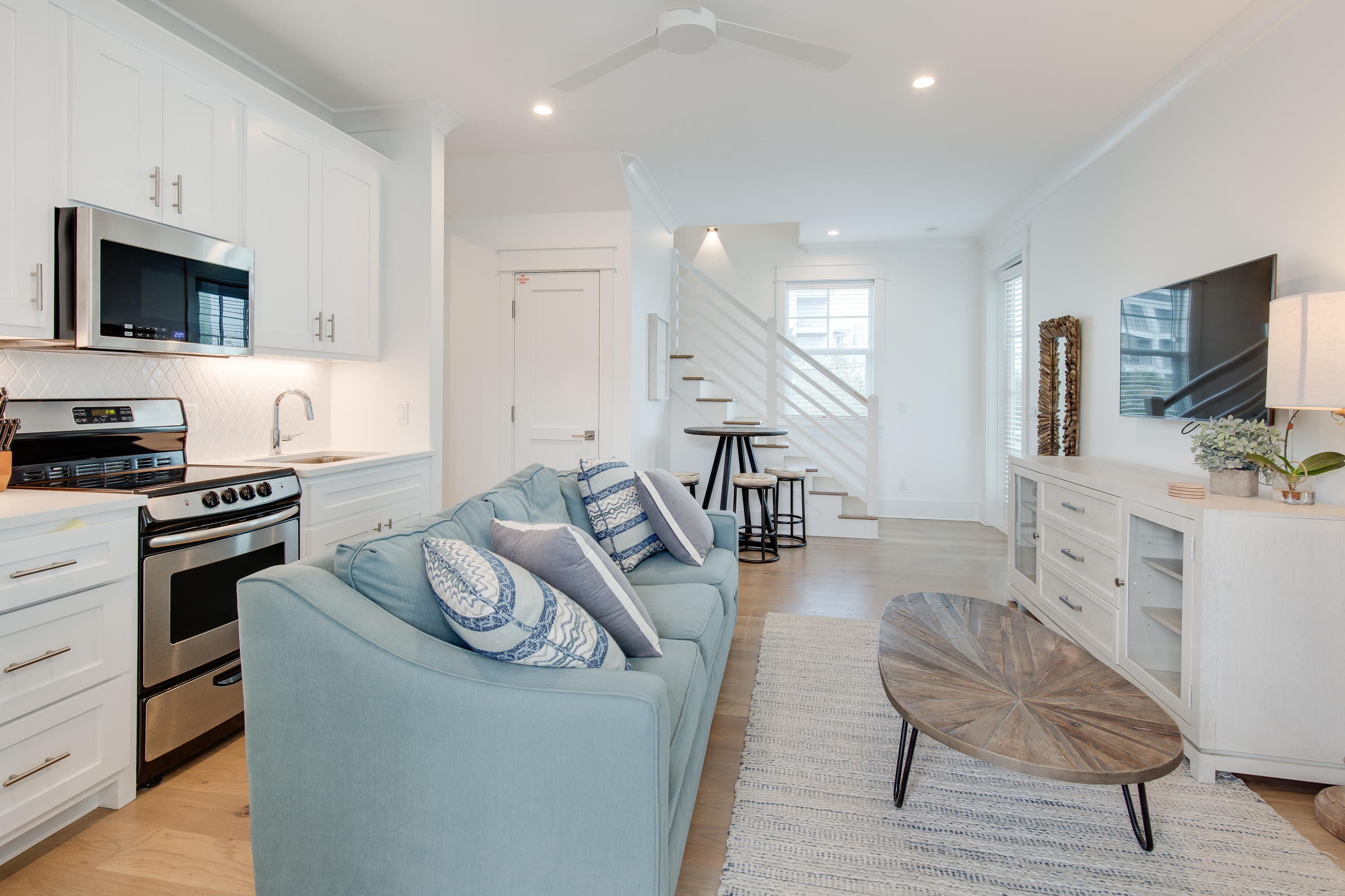 94 Pine Crest Circle Rosemary Beach, FL 32461 - Photo 61 of 69 a living room with furniture a flat screen tv and kitchen view