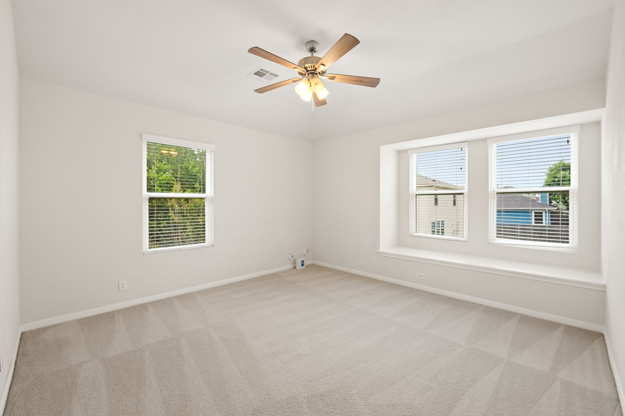 8902 Magna Carta Loop, Unit 122 Austin, TX 78754 - Photo 21 of 39 A quiet, well-lit bedroom with soft carpeting and ample natural illumination from multiple windows.