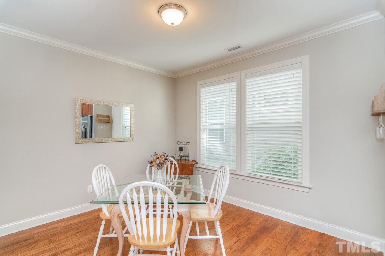 1141 Chapanoke Road Raleigh, NC 27603 - Photo 13 of 25 a view of a dining room with furniture and wooden floor