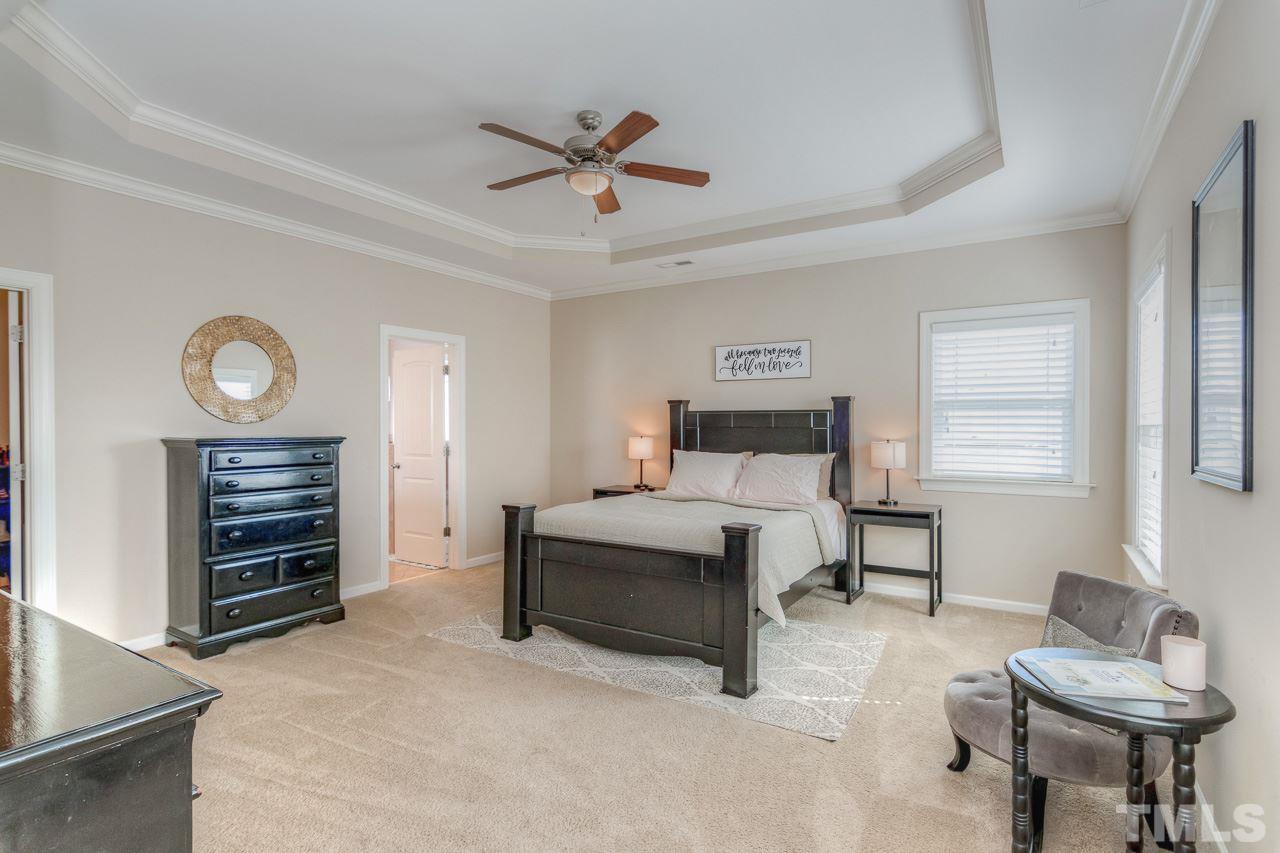 1141 Chapanoke Road Raleigh, NC 27603 - Photo 15 of 25 a spacious bedroom with a bed and a couch