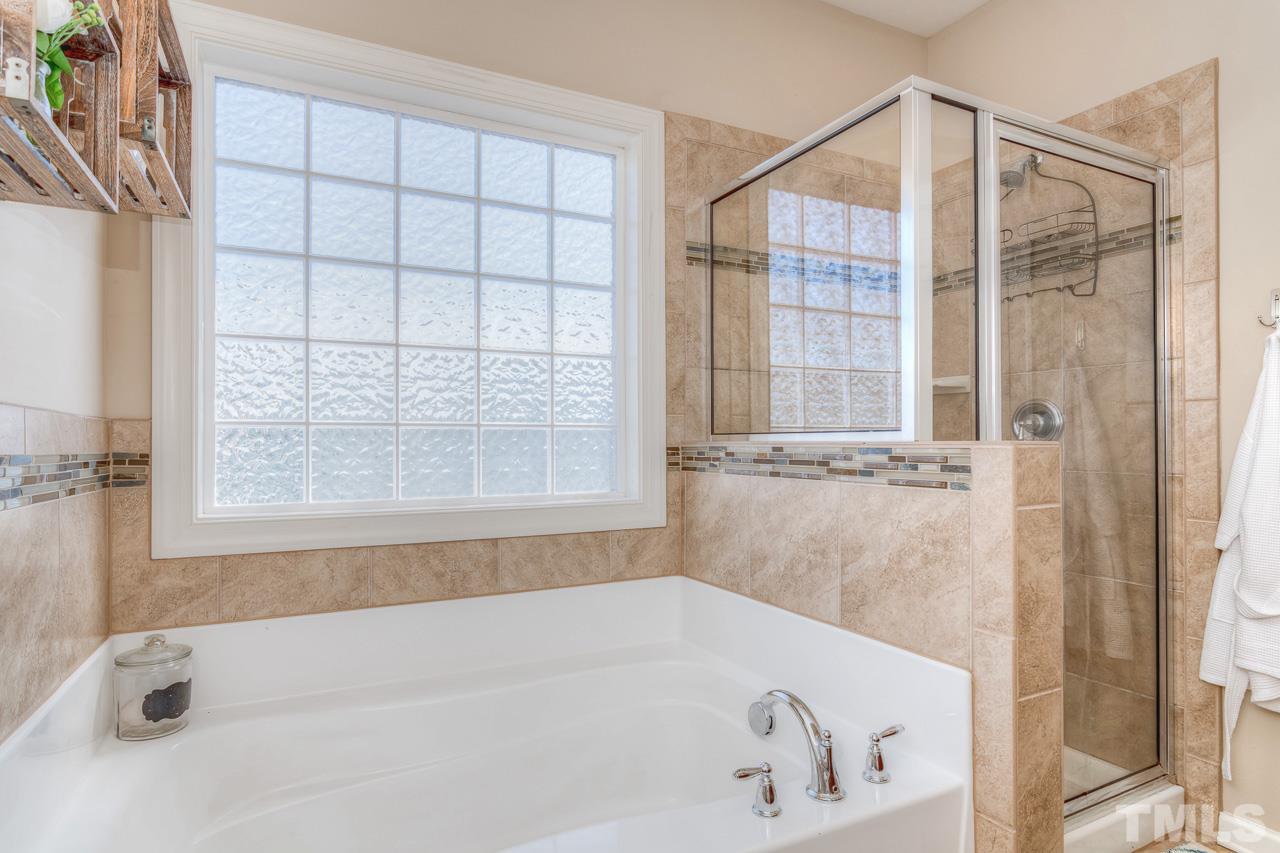1141 Chapanoke Road Raleigh, NC 27603 - Photo 17 of 25 a bathroom with a bathtub and a shower
