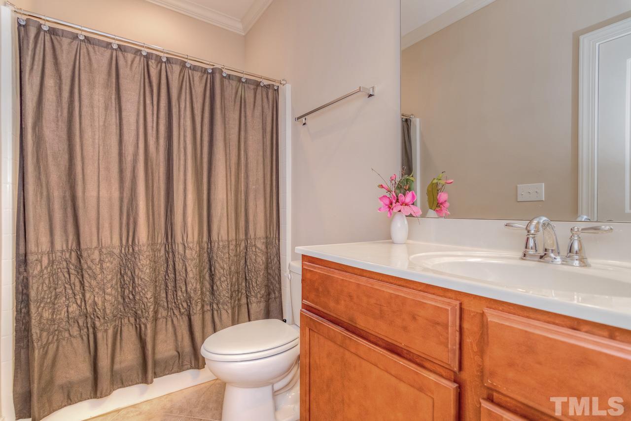 1141 Chapanoke Road Raleigh, NC 27603 - Photo 23 of 25 a bathroom with a sink toilet and shower