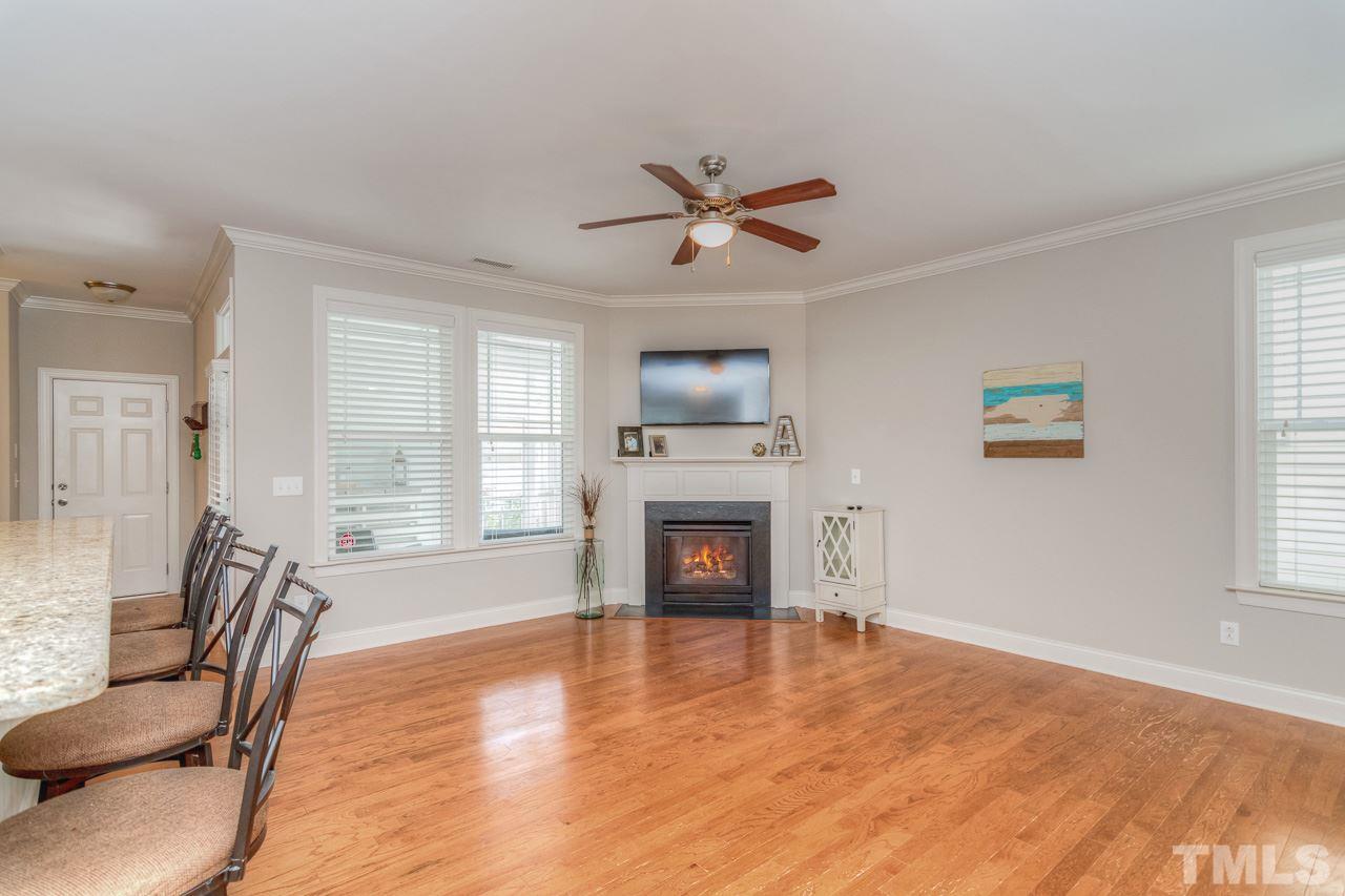 1141 Chapanoke Road Raleigh, NC 27603 - Photo 7 of 25 a view of a livingroom with a fireplace window and wooden floor