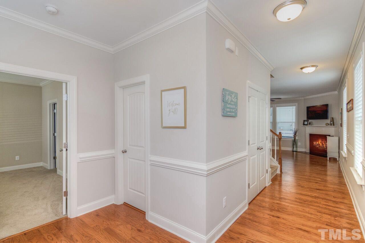 1141 Chapanoke Road Raleigh, NC 27603 - Photo 8 of 25 a view of a hallway with wooden floor and dining room