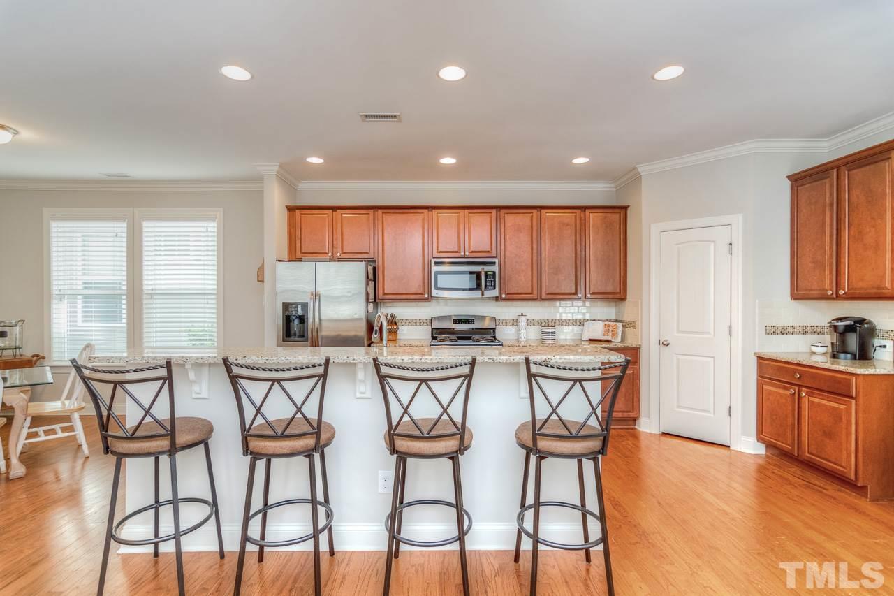 1141 Chapanoke Road Raleigh, NC 27603 - Photo 9 of 25 a view of a dining room with furniture and wooden floor