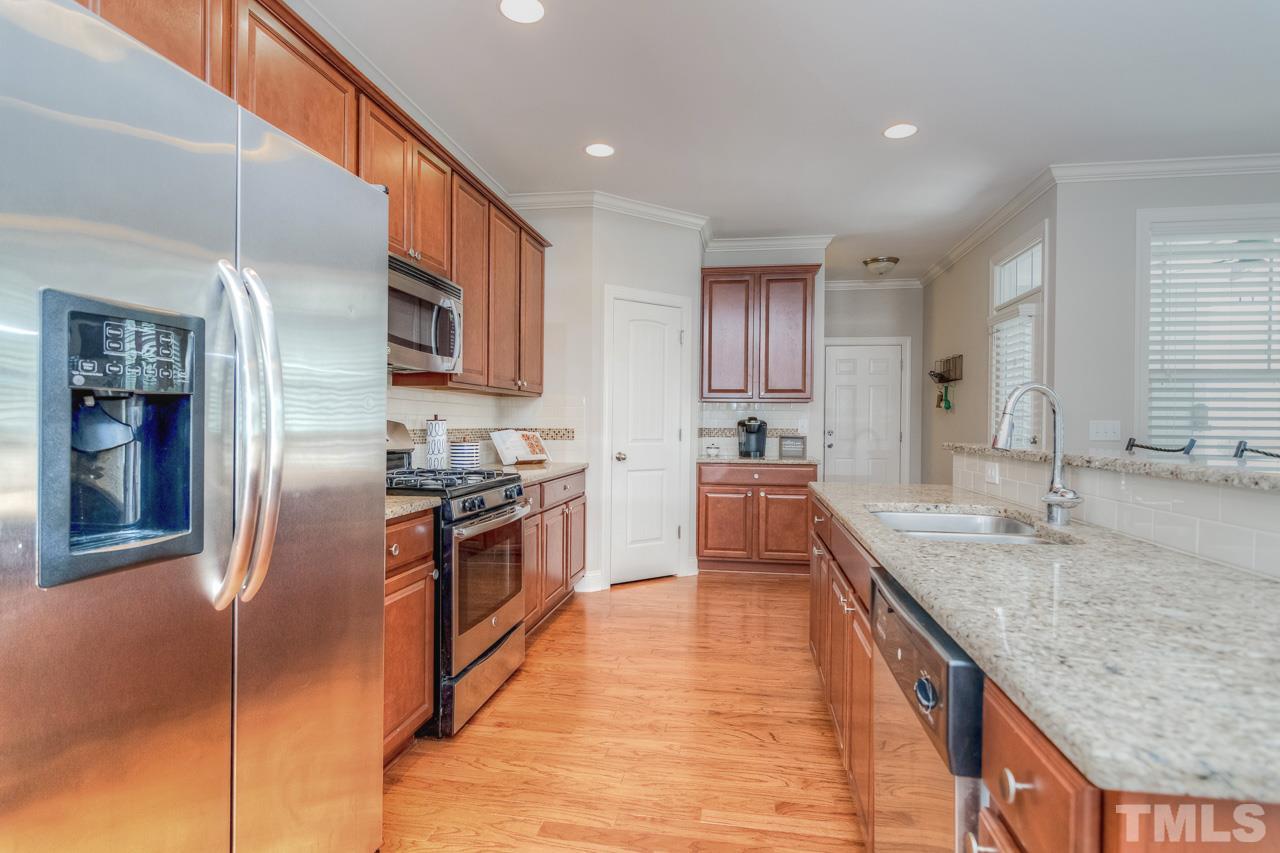 1141 Chapanoke Road Raleigh, NC 27603 - Photo 10 of 25 a large kitchen with stainless steel appliances granite countertop a sink and refrigerator