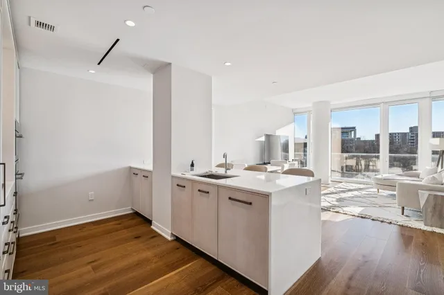 a kitchen with sink a stove and cabinets