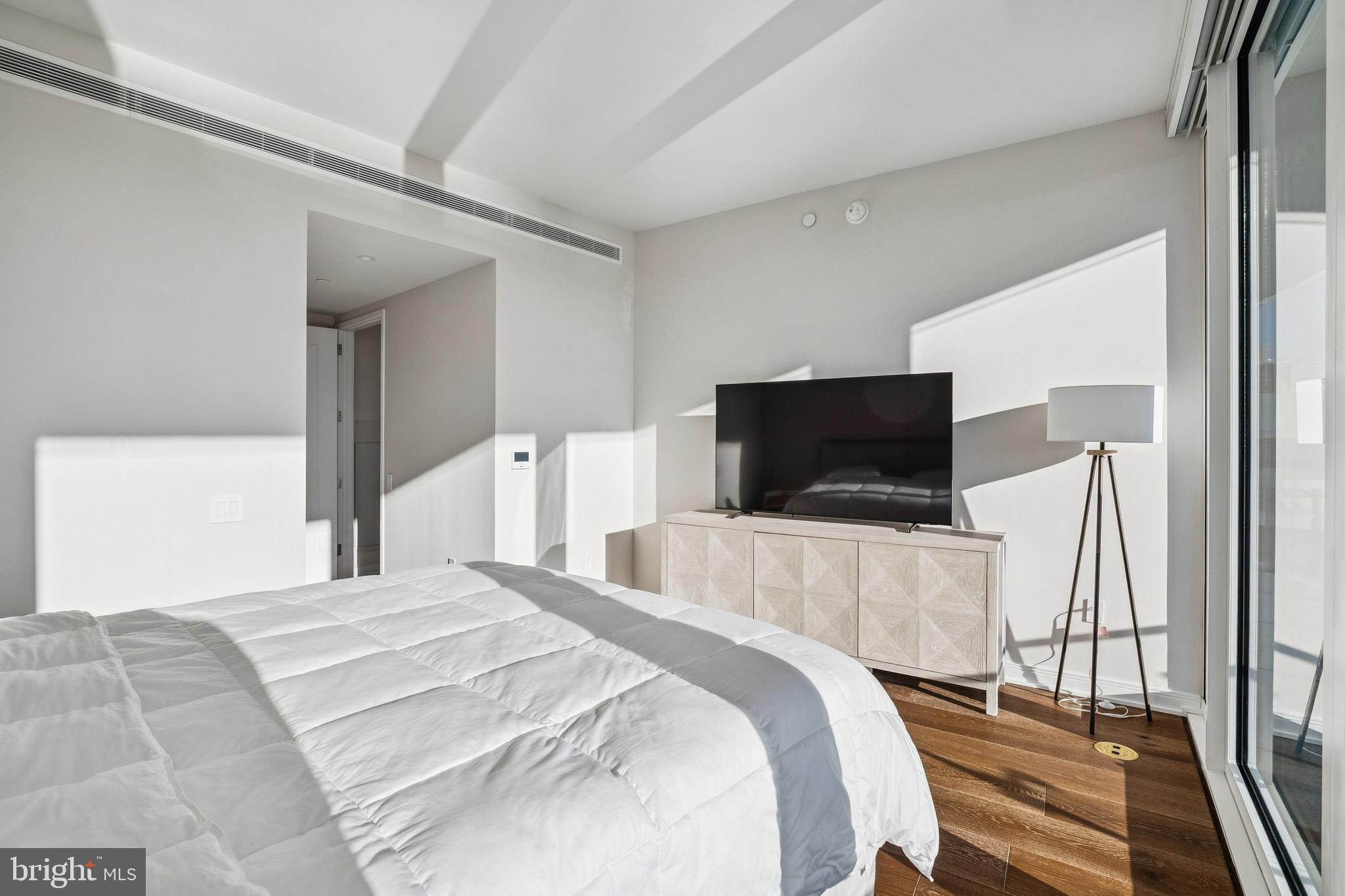 601 Wharf Street Southwest, Unit 504 Washington, DC 20024 - Photo 15 of 39 a bedroom with a bed and a flat screen tv