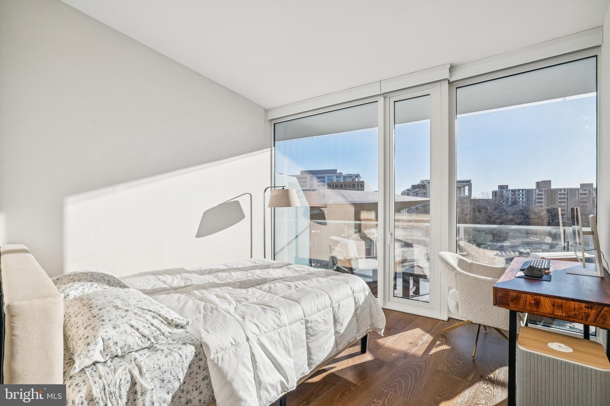 601 Wharf Street Southwest, Unit 504 Washington, DC 20024 - Photo 20 of 39 a bedroom with a large bed and a night stand