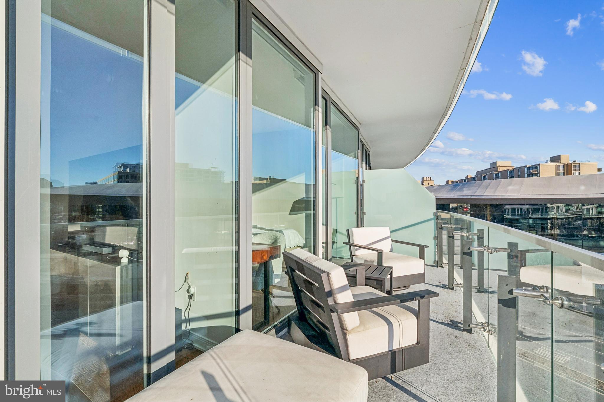601 Wharf Street Southwest, Unit 504 Washington, DC 20024 - Photo 22 of 39 a balcony with chairs and view of living room