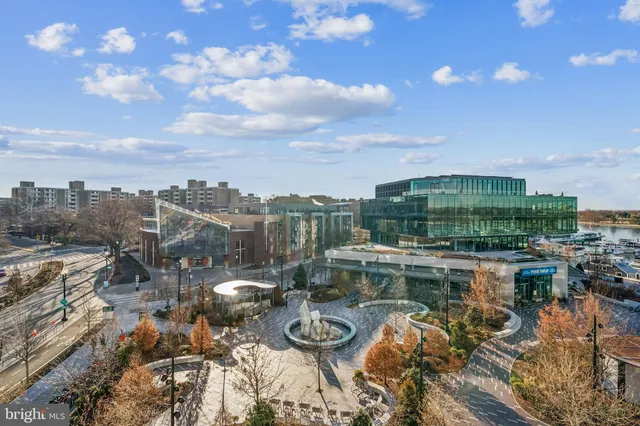 a view of a porch with chairs and potted plants