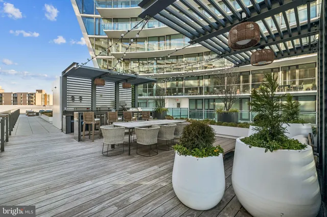 a view of a roof deck with couches and wooden floor
