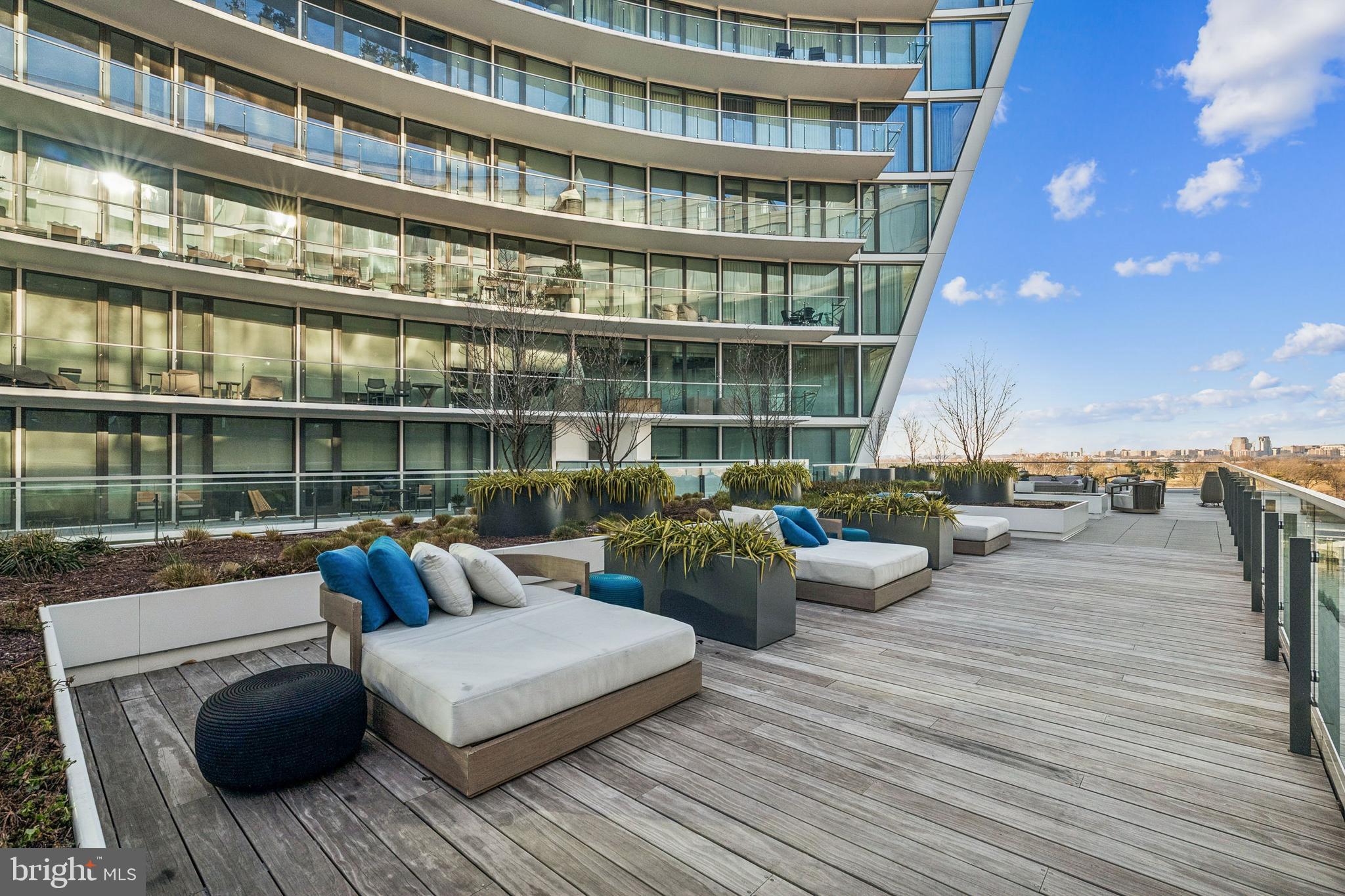 601 Wharf Street Southwest, Unit 504 Washington, DC 20024 - Photo 28 of 39 a view of a roof deck with couches and wooden floor