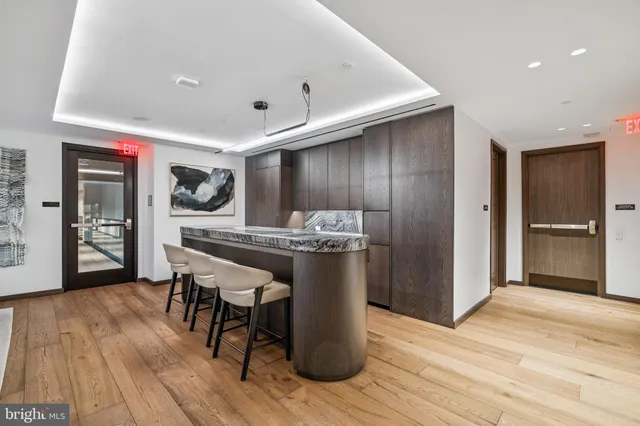 a living room with a bed and a flat screen tv