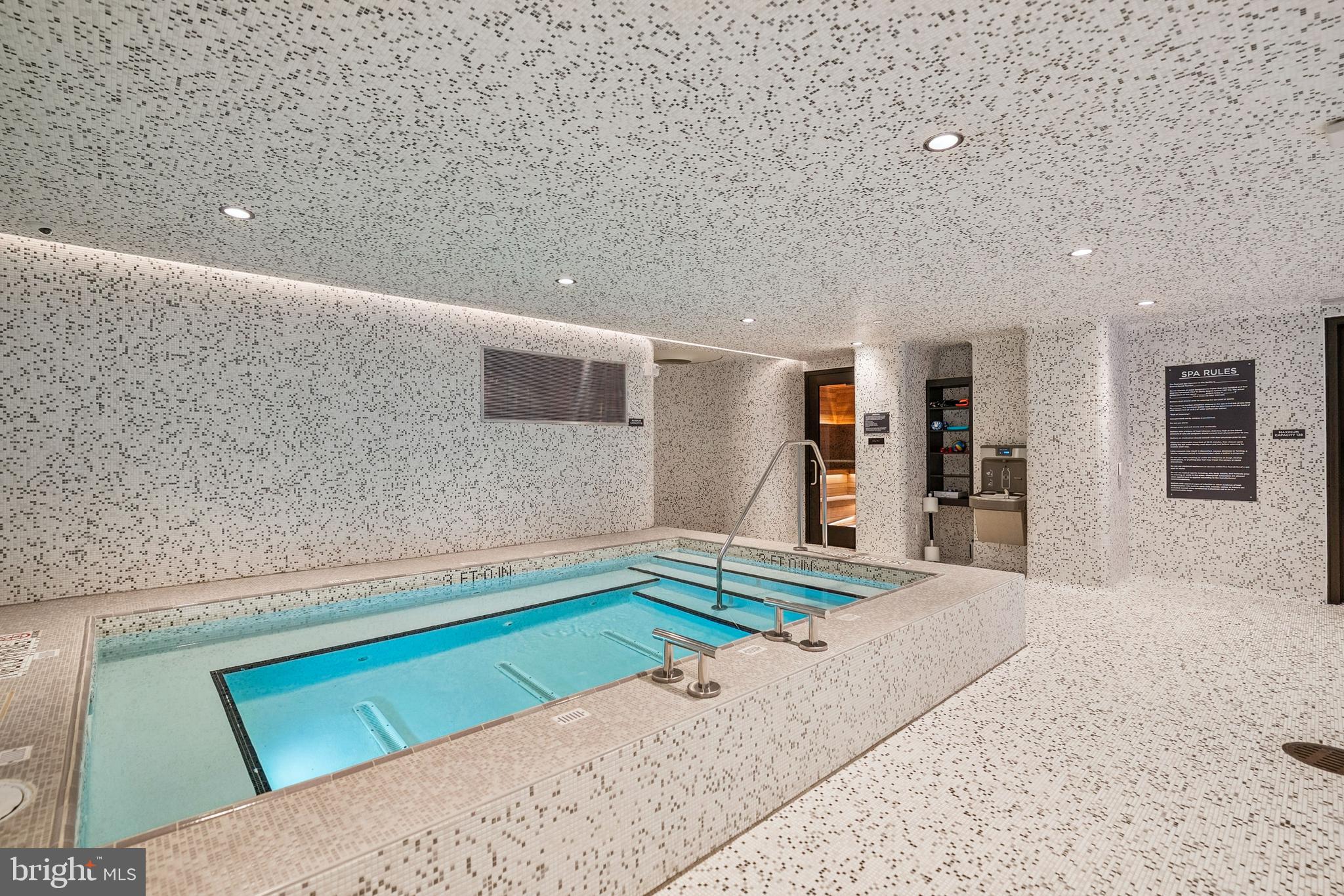 601 Wharf Street Southwest, Unit 504 Washington, DC 20024 - Photo 38 of 39 a living room with a bed and a flat screen tv