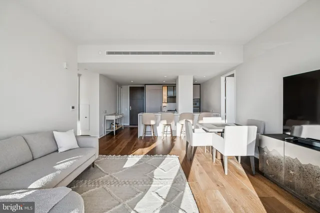 a living room with furniture and view of kitchen