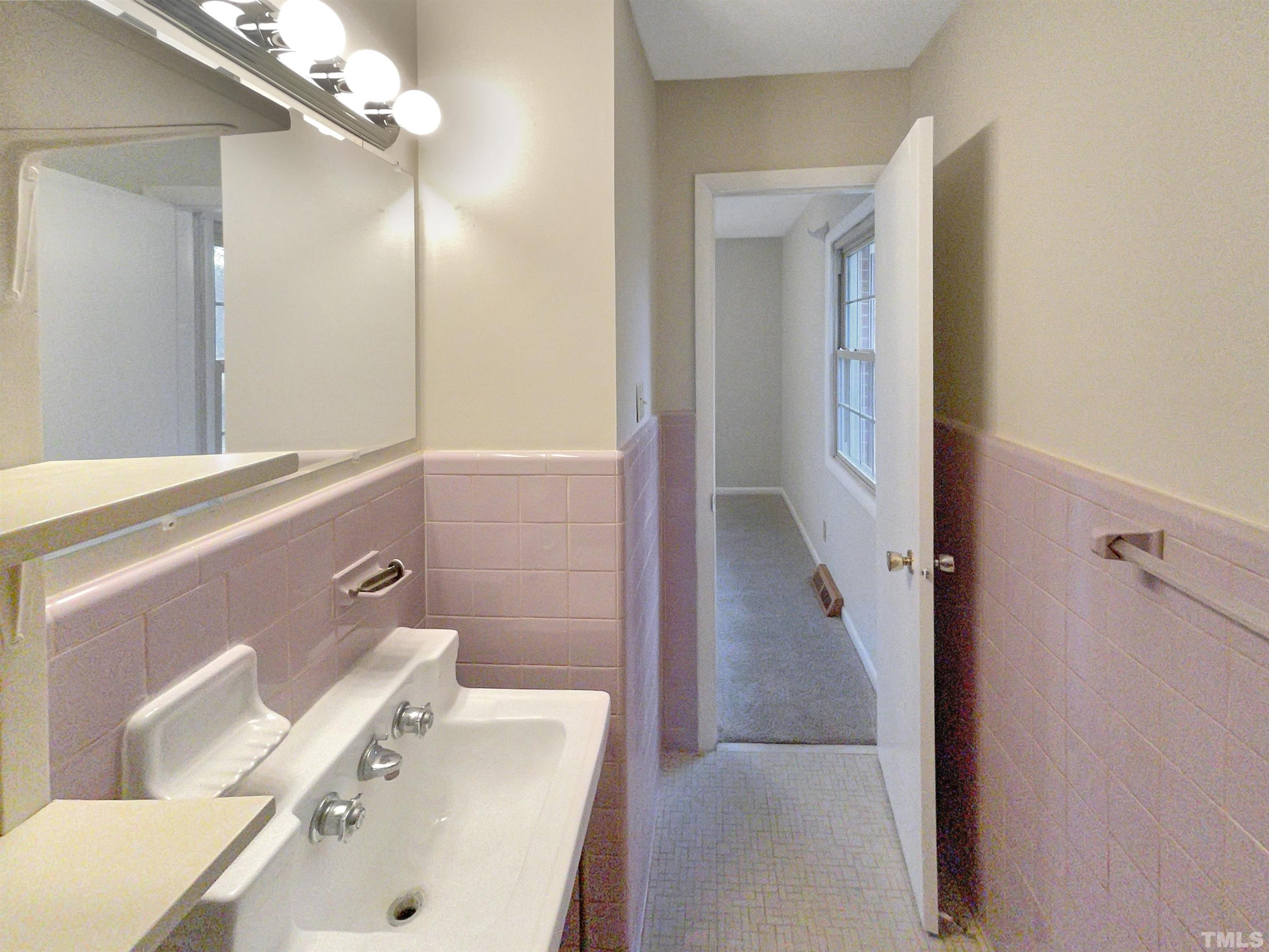 5333 Olive Road Raleigh, NC 27606 - Photo 17 of 18 a bathroom with a sink and a mirror