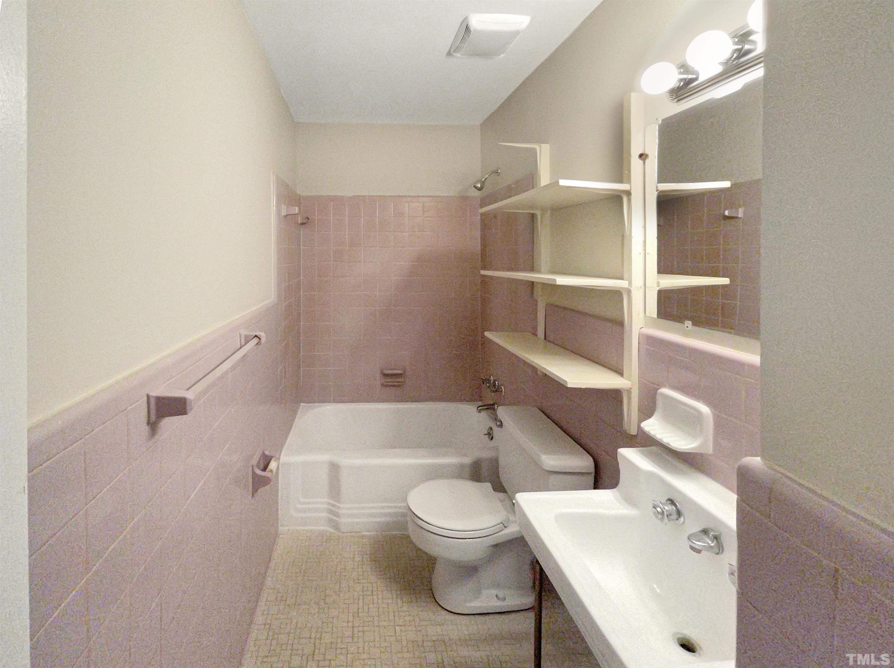 5333 Olive Road Raleigh, NC 27606 - Photo 4 of 18 a bathroom with a sink a toilet and shower