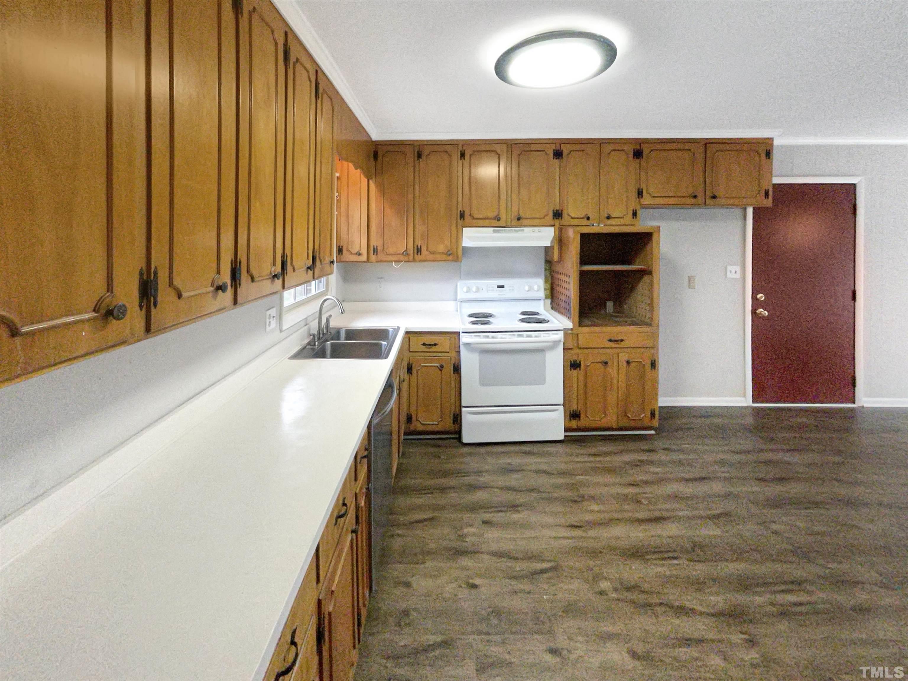 5333 Olive Road Raleigh, NC 27606 - Photo 8 of 18 a kitchen with stainless steel appliances granite countertop a sink a stove and a refrigerator