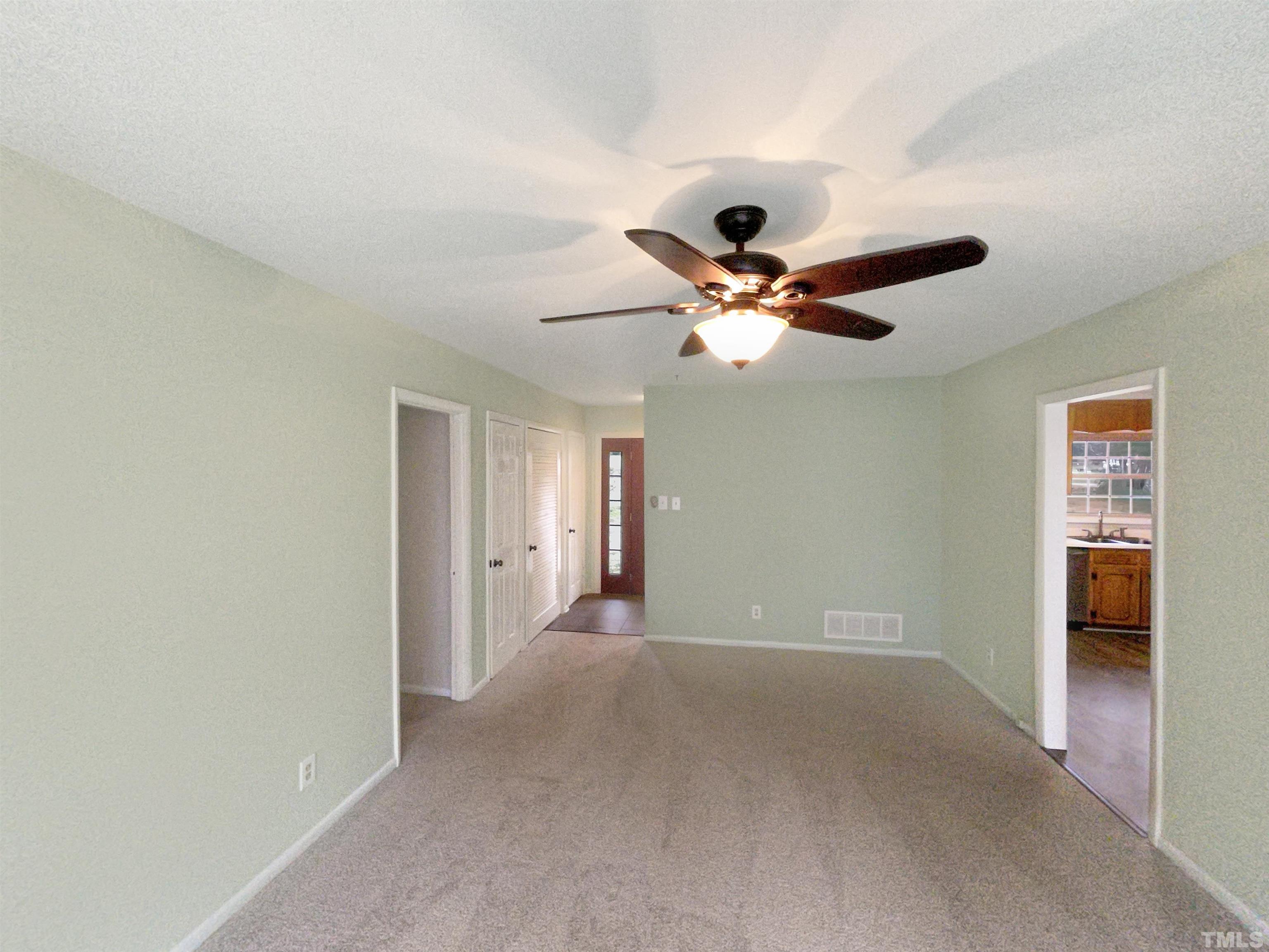 5333 Olive Road Raleigh, NC 27606 - Photo 10 of 18 a view of a livingroom with a ceiling fan and wooden floor