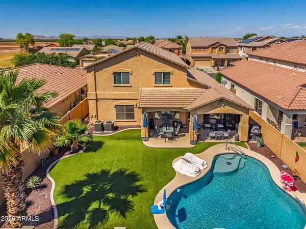 an aerial view of a house with swimming pool patio and outdoor seating