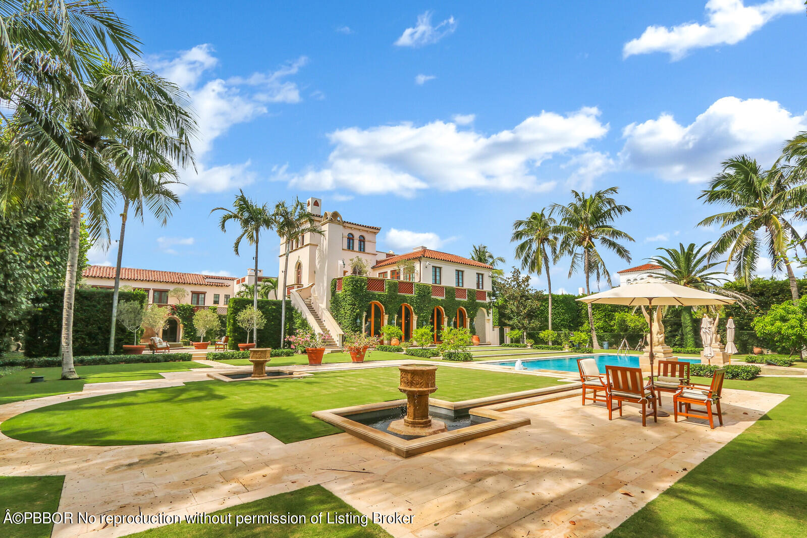 120 Jungle Road Palm Beach, FL 33480 - Photo 2 of 21 a view of a swimming pool with lawn chairs under an umbrella