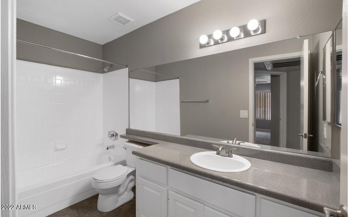 2025 East Campbell Avenue, Unit 366 Phoenix, AZ 85016 - Photo 7 of 18 a bathroom with a granite countertop sink toilet and shower