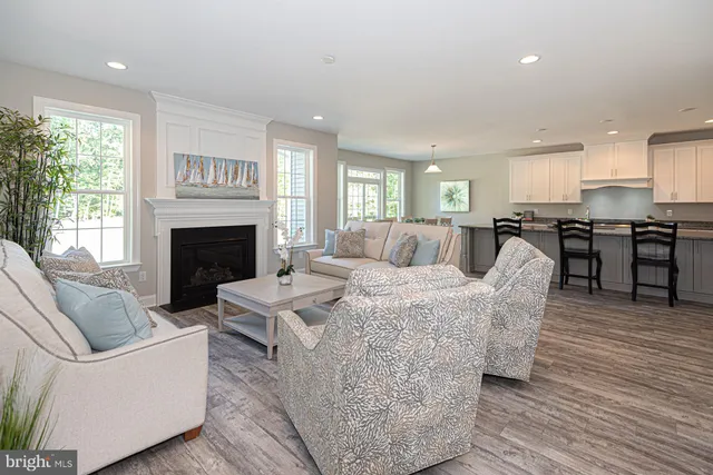 a living room with furniture fireplace and window