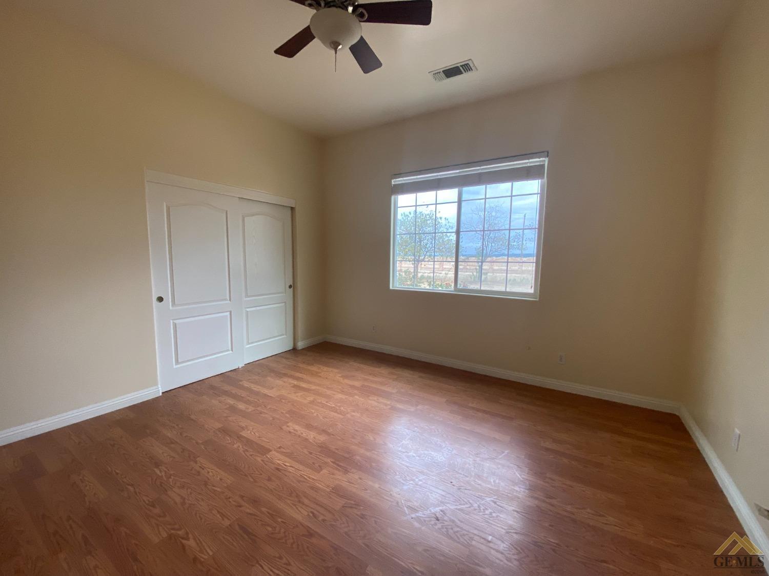 Undisclosed Address Bakersfield, CA 93307 - Photo 16 of 36 an empty room with windows and fan