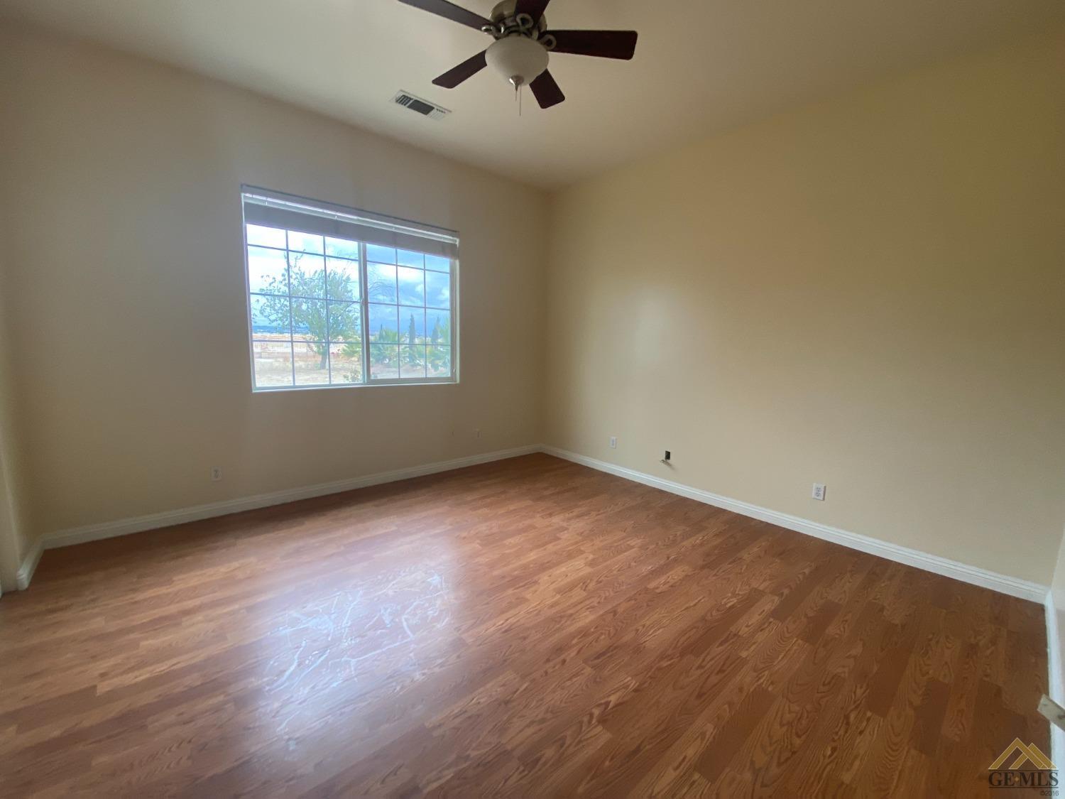 Undisclosed Address Bakersfield, CA 93307 - Photo 17 of 36 an empty room with windows and ceiling fan view