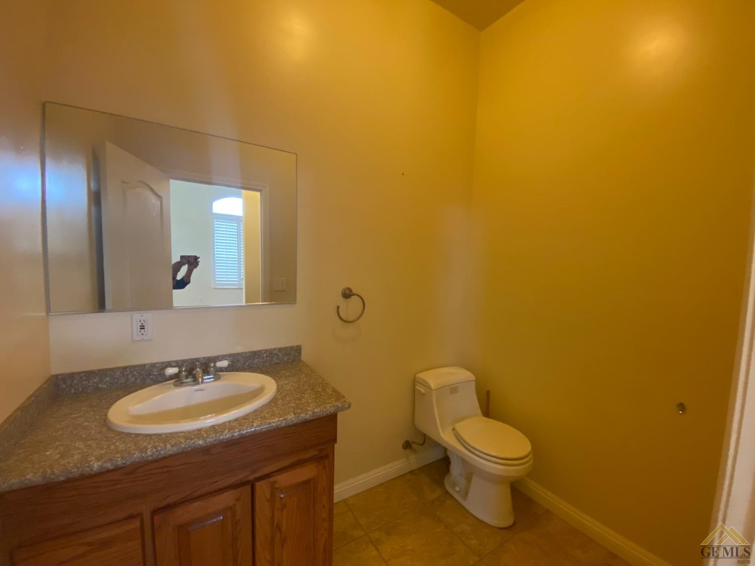 Undisclosed Address Bakersfield, CA 93307 - Photo 19 of 36 a bathroom with a granite countertop sink and a mirror