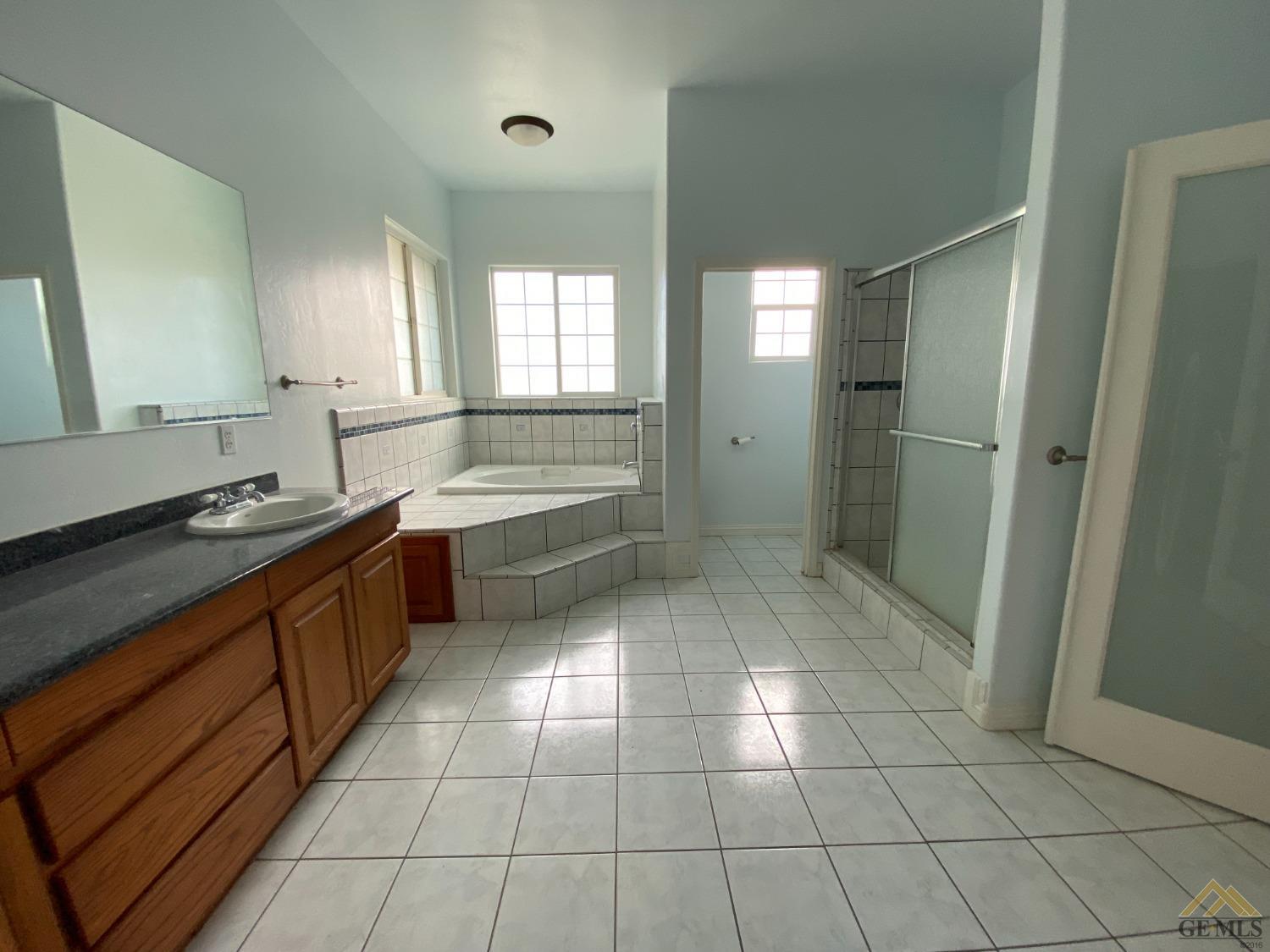 Undisclosed Address Bakersfield, CA 93307 - Photo 25 of 36 a large kitchen with a sink and cabinets
