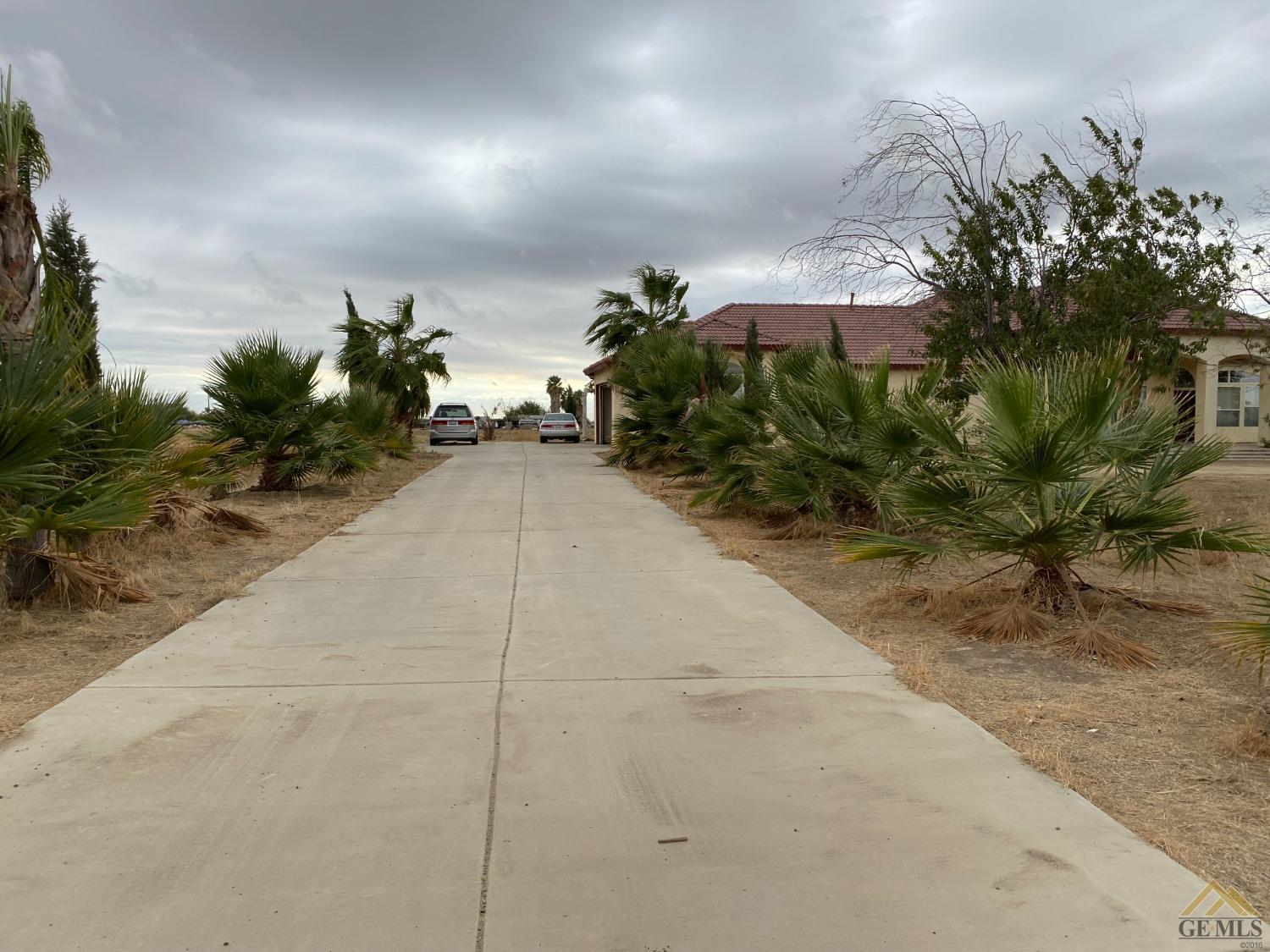 Undisclosed Address Bakersfield, CA 93307 - Photo 3 of 36 a house with potted plants in front of it