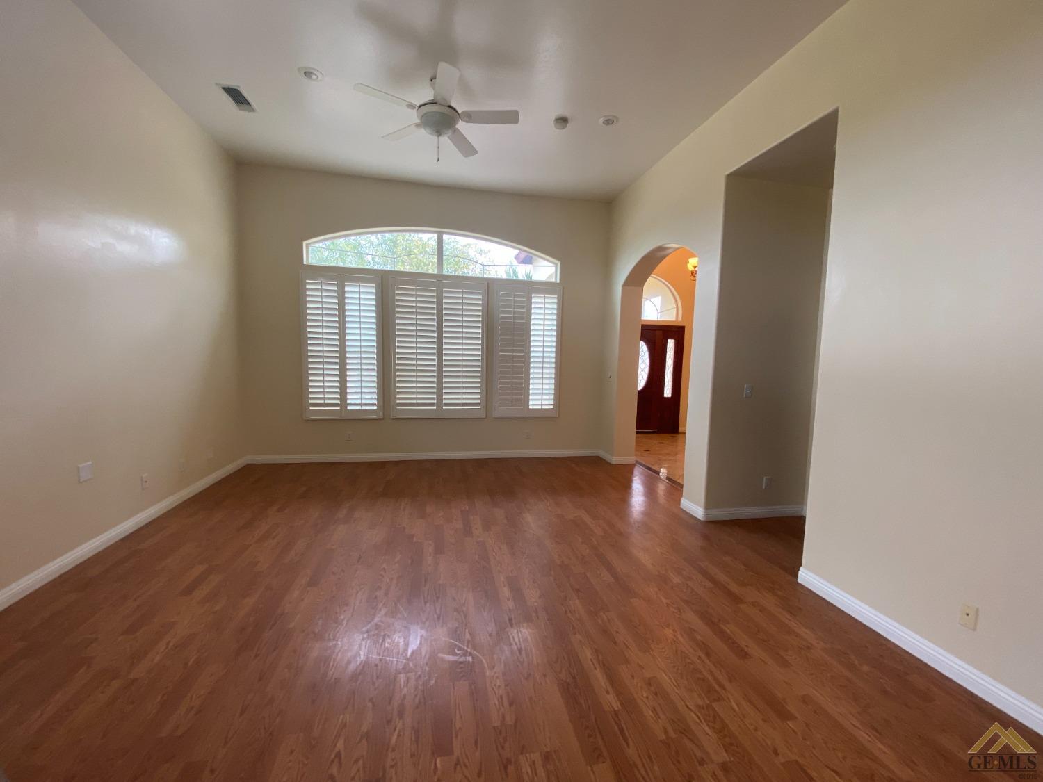Undisclosed Address Bakersfield, CA 93307 - Photo 6 of 36 an empty room with wooden floor and windows