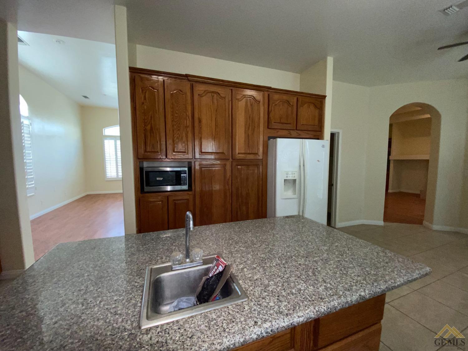 Undisclosed Address Bakersfield, CA 93307 - Photo 8 of 36 a kitchen with stainless steel appliances granite countertop a sink and a refrigerator