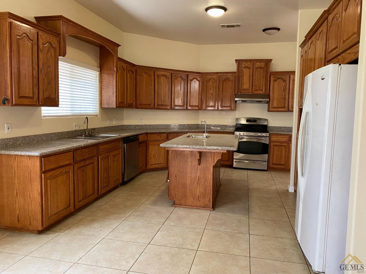 Undisclosed Address Bakersfield, CA 93307 - Photo 9 of 36 a kitchen with stainless steel appliances granite countertop a stove a sink a microwave and a refrigerator