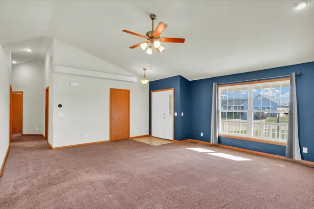 a view of an empty room with window and cabinet