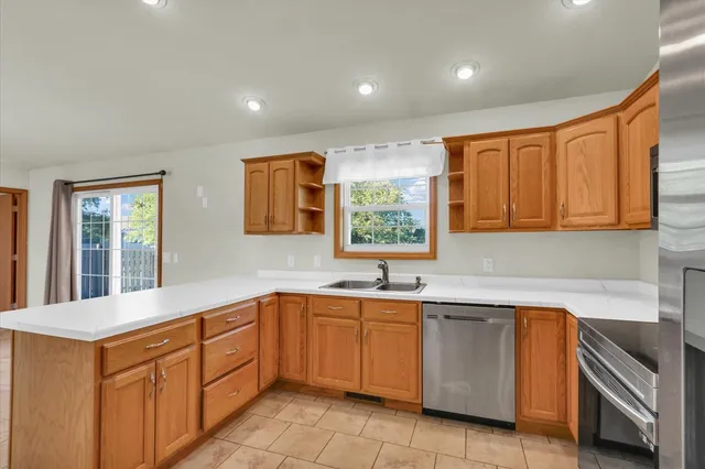 a kitchen with a sink stove and microwave