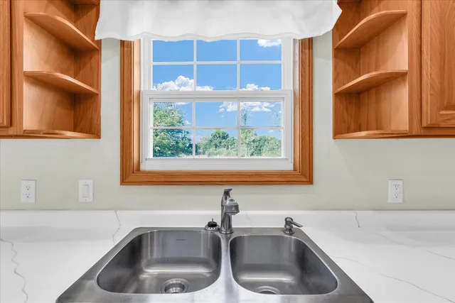 a bathroom with a sink and a window