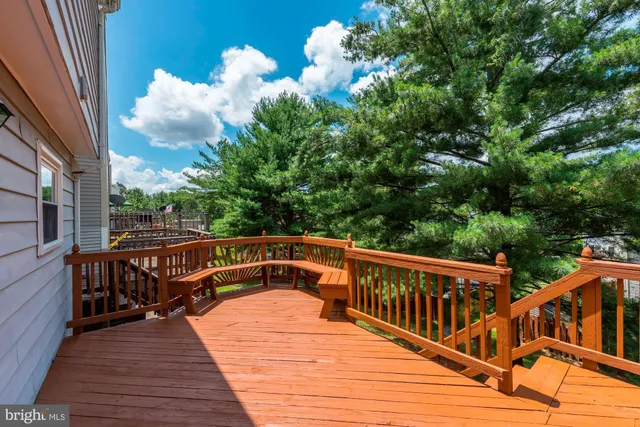 a view of balcony with wooden floor and seating space