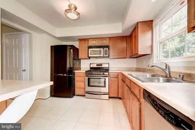 a kitchen with a refrigerator stove and sink