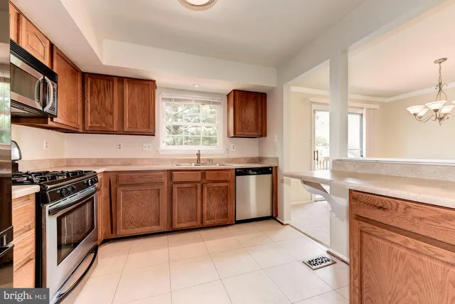 a kitchen with granite countertop a stove top oven sink and cabinets