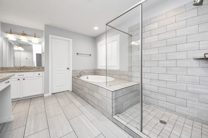 4222 Drake Street Houston, TX 77005 - Photo 19 of 28 a bathroom with a granite countertop sink a toilet and shower