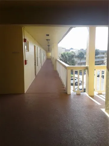 a view of a hallway with two windows