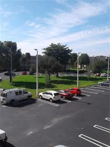 a view of a street with lawn chairs