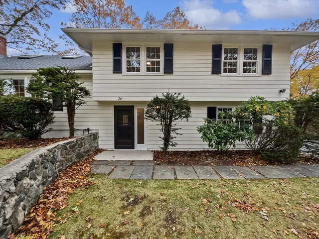 a kitchen with wooden cabinets and stainless steel appliances