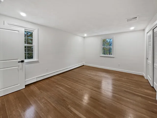 a bathroom with a granite countertop sink a mirror and shower
