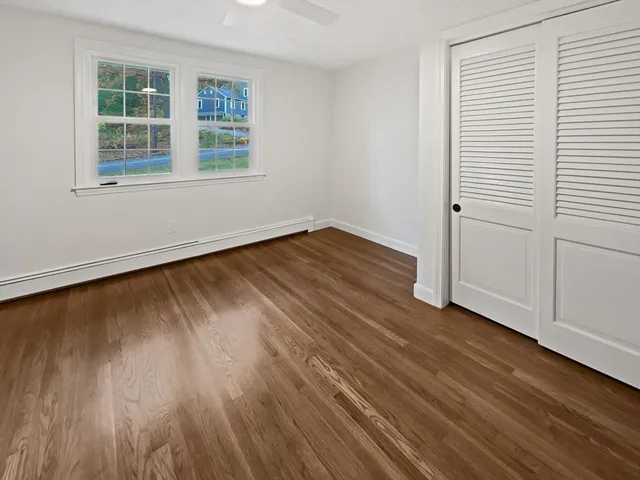 a view of an empty room and wooden floor