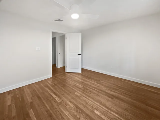 a bathroom with a granite countertop sink and a bathtub
