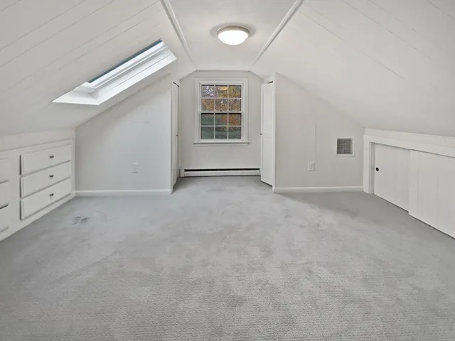 an empty room with wooden floor and fireplace
